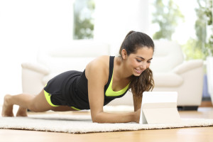 Fitness woman exercising with online training app